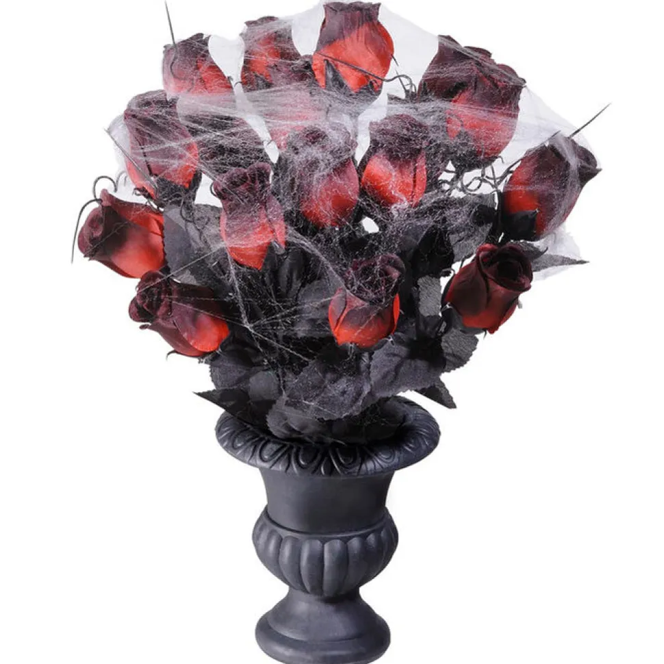 Vase mit roten Rosen und Spinnennetz
